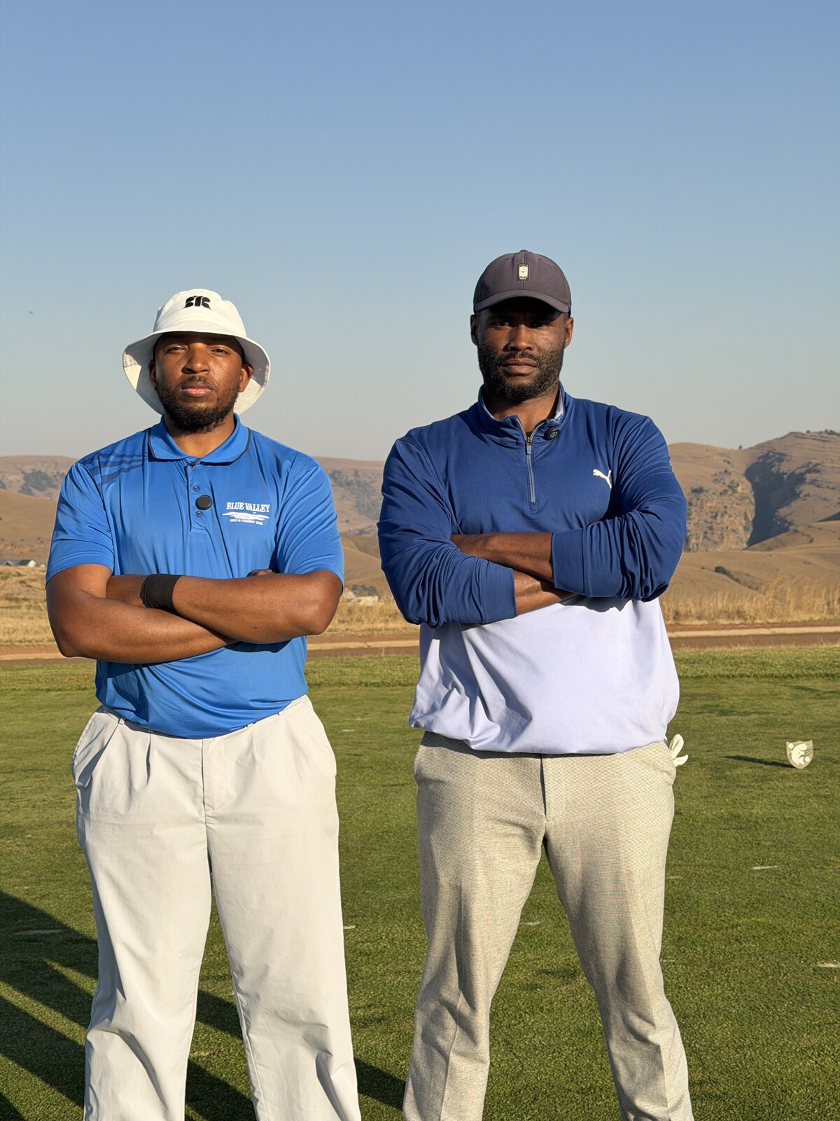 Tshepo and Mangezi with arms folded on a tee box at Blue Valley Golf & Country Club